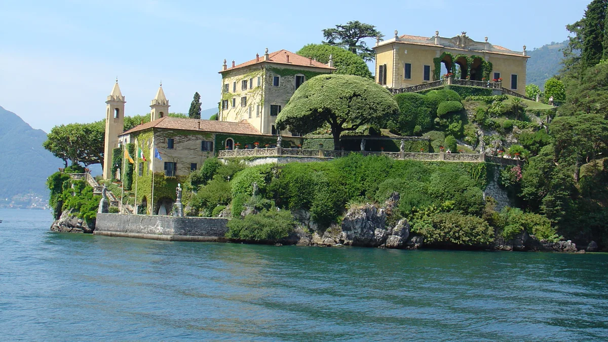 Lakeside classical stone balustrades overlooking calm blue alpine waters